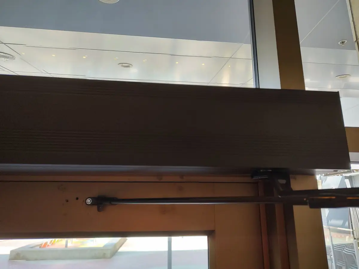 Automatic door operator being installed on a commercial swing door