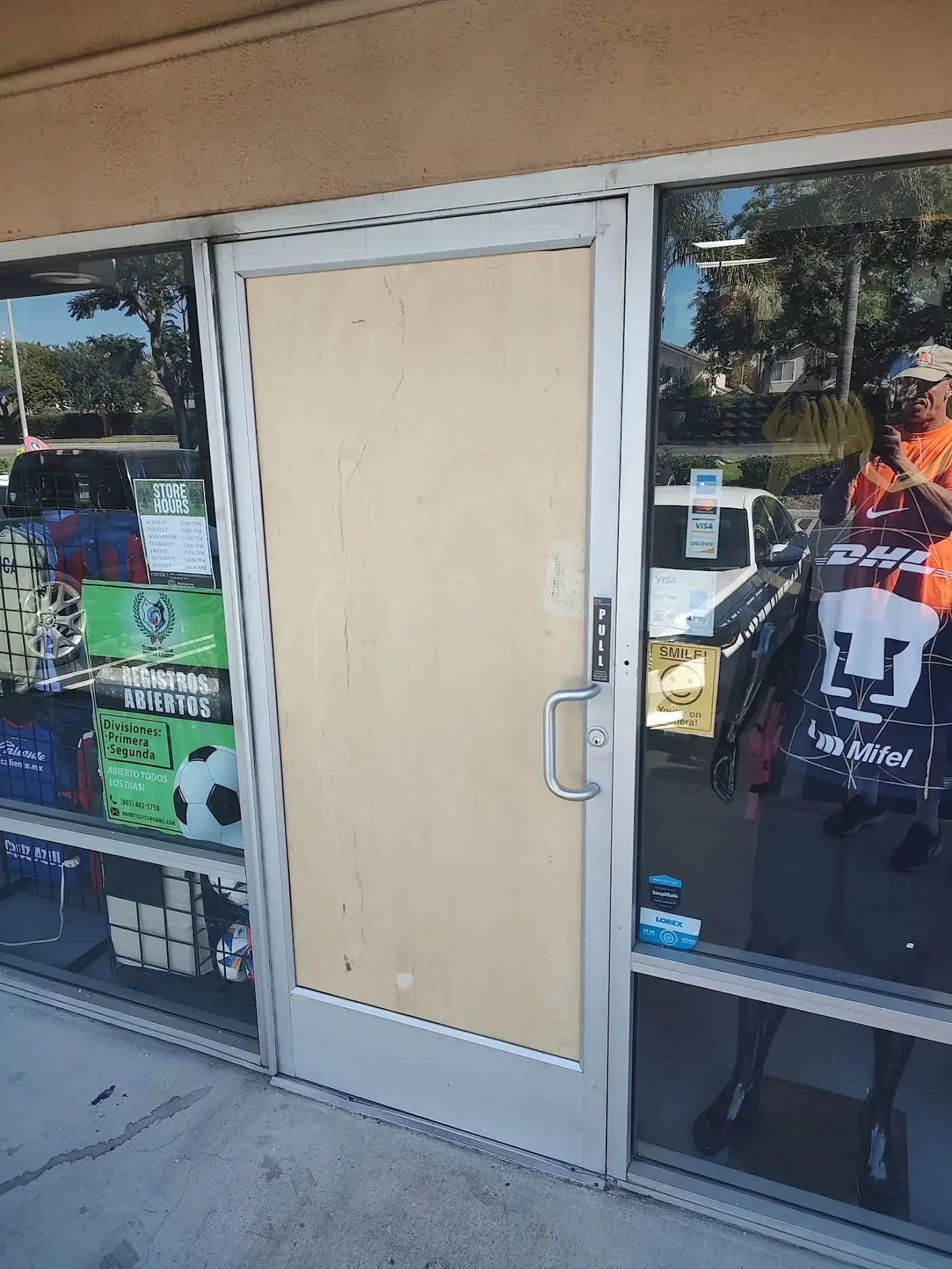 Emergency door and window board-up service securing a damaged storefront in Oxnard, CA