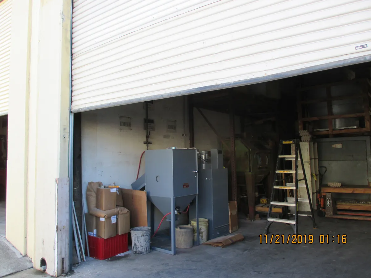 Newly installed rolling steel roll-up door on a commercial building